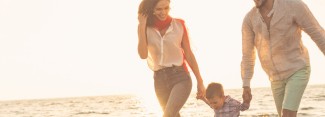 Photo: Family walking along the beach