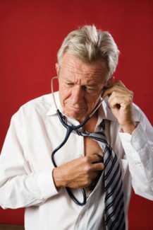 Photo: Man with a Stethescope Checking his Own Vitals