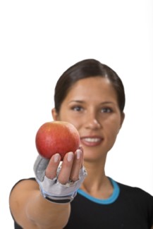 Photo: Woman in Workout Gear Holding an Apple