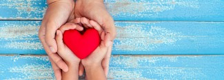 Photo: Child and Mother holding a Red Heart
