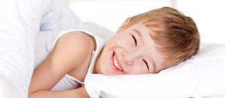 Photo: Boy Smiling in Bed