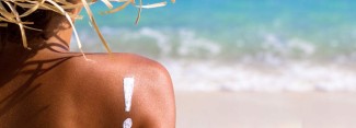 Photo: Person on a Beach with Sunscreen in the Shape of an Exclamation Point