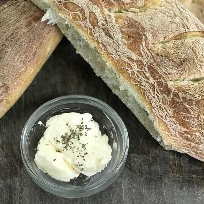 Photo: Bread loaves with a bowl of vegan goat cheese