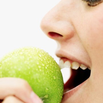 Photo: Woman Biting into an Apple