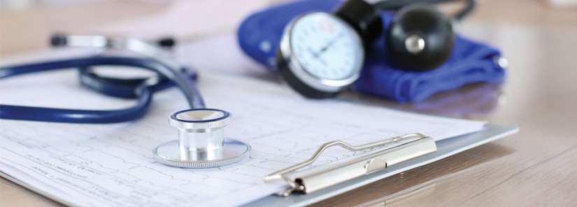 Photo: Stethoscope with a chart showing vital signs