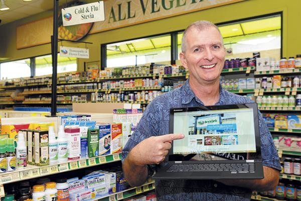 Photo: Mark Fergusson Holding a Laptop