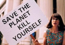 Photo: Woman Holding a Sign that Reads Save the Planet Kill Yourself