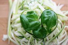 Photo: Delicious healthy zucchini topped with green leaves in a heart