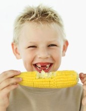 Photo: Boy Eating Corn on the Cob
