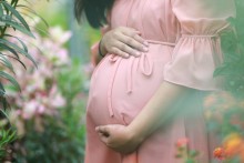 Photo: Pregnant woman in a garden