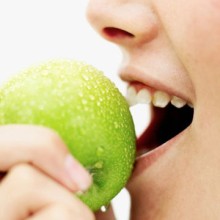 Photo: Person Biting into an Apple