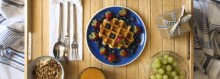 Breakfast Table with Fruit, Waffles, Grapes and Orange Juice