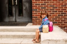 Photo: Girl Waiting Outside a School