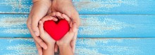 Photo: Child and Mother holding a Red Heart