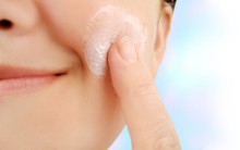 Photo: Woman Applying Sunscreen on Her Face