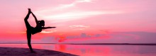 Photo: Woman Doing Yoga on the Beach